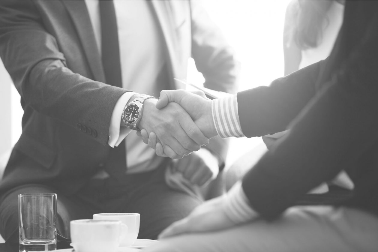 Attorney and client shake hands, symbolizing successful partnership in bankruptcy & creditors' rights with CP&M Law