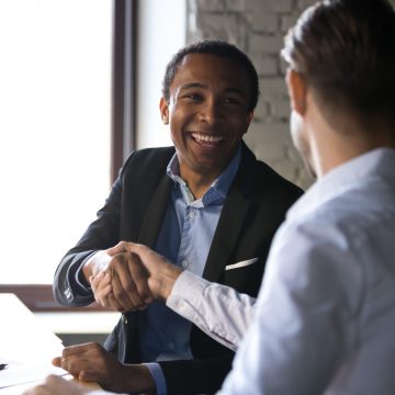 Businessmen shaking hands - Trust Carlile Patchen & Murphy LLP for comprehensive business transaction guidance and expertise.